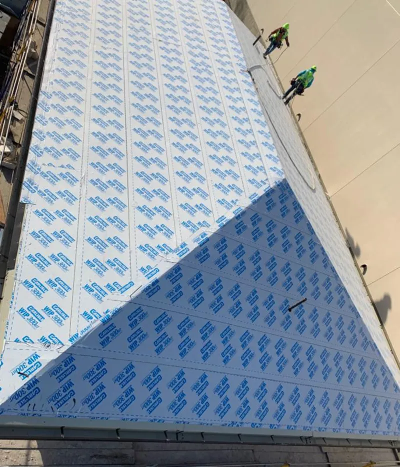 Professional roofers installing underlayment on a metal roof in Battlefield